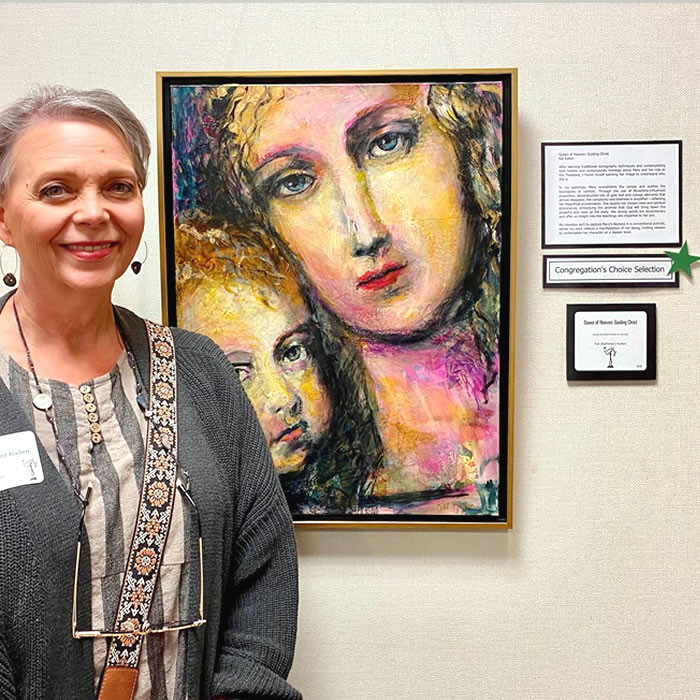 kat kallen standing next to award winning painting of Mary, Jesus' mother at Grand Rapids Celebration of the Art Liturgical Art Festival